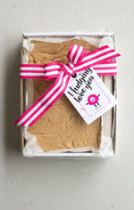 Load image into Gallery viewer, One kilogram white chocolate fudge slab in a sturdy cardboard tray, finished with a pink striped ribbon and &#39;I Fudging Love You&#39; swing tag
