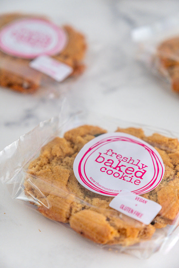 Vegan gluten-free peanut butter cookies in branded packaging