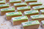Load image into Gallery viewer, Bars of springbokkie fudge with green and white packaging on a light surface
