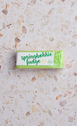 Load image into Gallery viewer, Bar of springbokkie fudge on a terrazzo countertop
