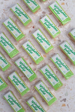 Load image into Gallery viewer, Multiple bars of springbokblikie fudge arranged on a textured surface.

