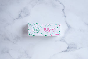 A white box sits on a neutral background. Large hunter green lettering states 'fudge' and is surrounded by hunter green and cerise pink paint splashes.
