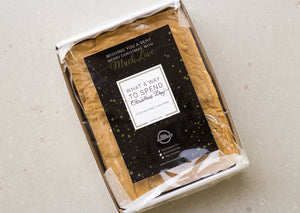 One kilogram slab of gingerbread fudge in a sturdy white cardboard tray - finished with a black and gold 'Merry Christmas' sticker.
