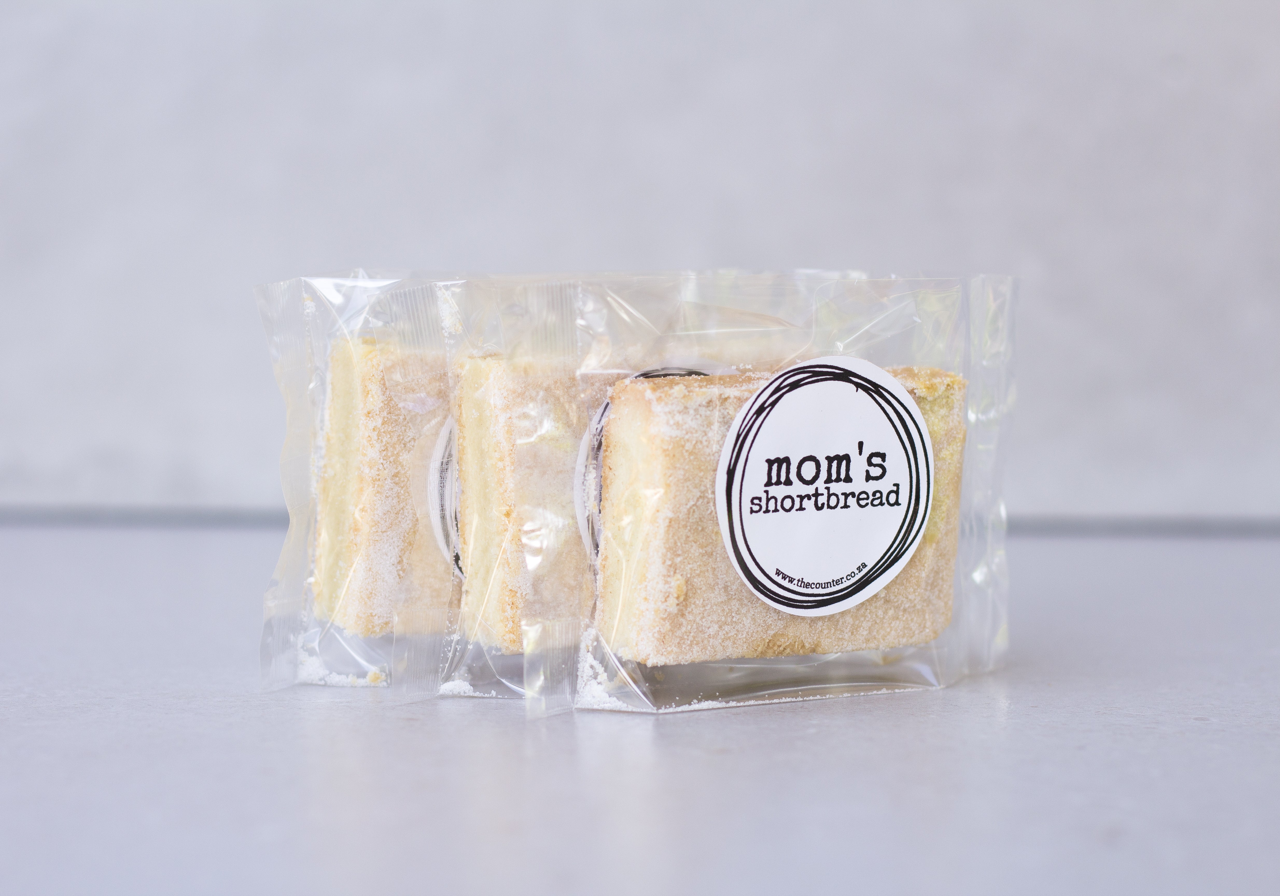 Mom's shortbread - traditional Scottish butter shortbread, packaged in cellophane and finished with a black sticker that says 'Mom's Shortbread'.