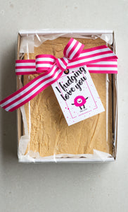 One kilogram white chocolate fudge slab in a sturdy cardboard tray, finished with a pink striped ribbon and 'I Fudging Love You' swing tag