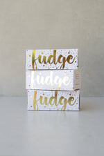 Load image into Gallery viewer, Gold foiled white box filled with gingerbread fudge.
