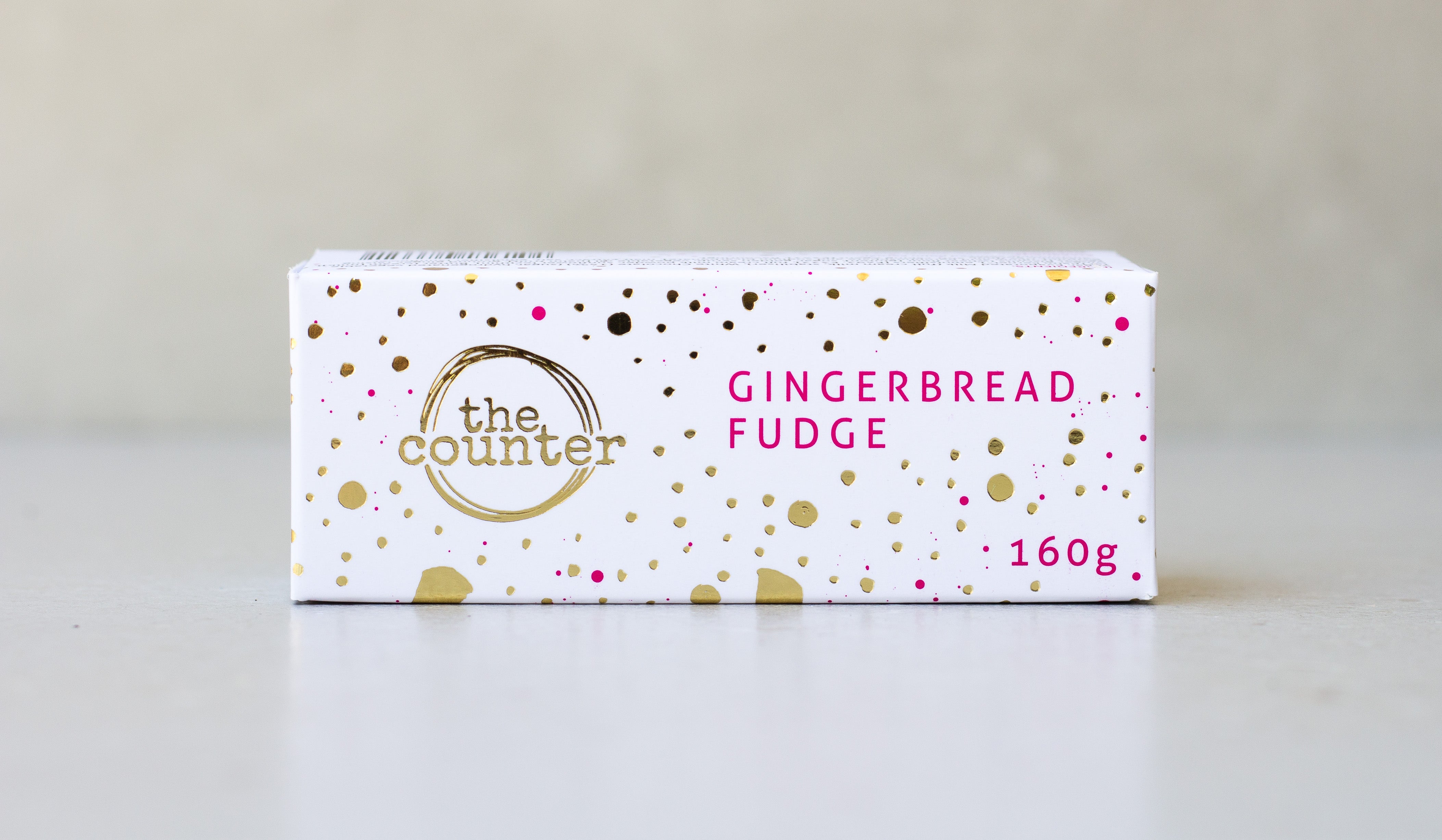 Gold foiled white box filled with gingerbread fudge.