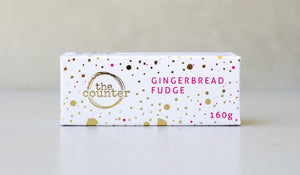 Gold foiled white box filled with gingerbread fudge.