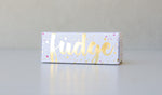 Load image into Gallery viewer, Gold foiled white box filled with gingerbread fudge.
