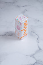 Load image into Gallery viewer, A white box sits on a neutral background. Paint splashes in orange and pink surround a messy circled logo for The Counter and the words ‘Peanut Butter Fudge&#39; and &#39;Fudge&#39; are written on different sides of the box in cerise pink block lettering.
