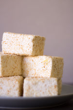 Load image into Gallery viewer, Pile of Toasted Coconut Marshmallows on a grey plate
