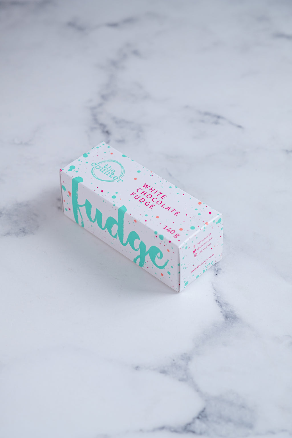 Fudge R Us Text White fudge box with large, cursive turquoise text and colourful paint ...
